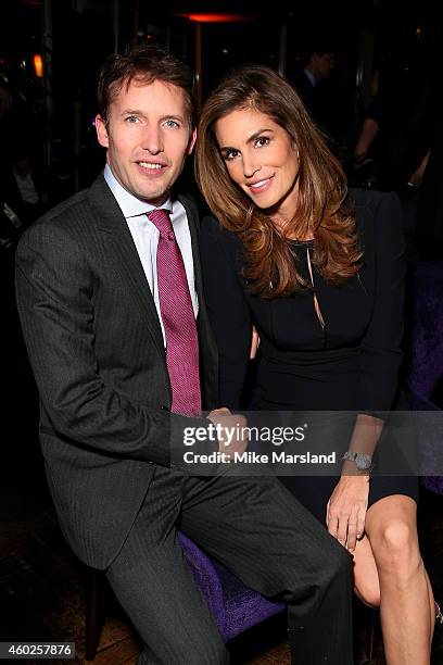 Singer James Blunt and model Cindy Crawford pose at the Omega Oxford Street Store Opening Party at The Shard on December 10, 2014 in London, England.