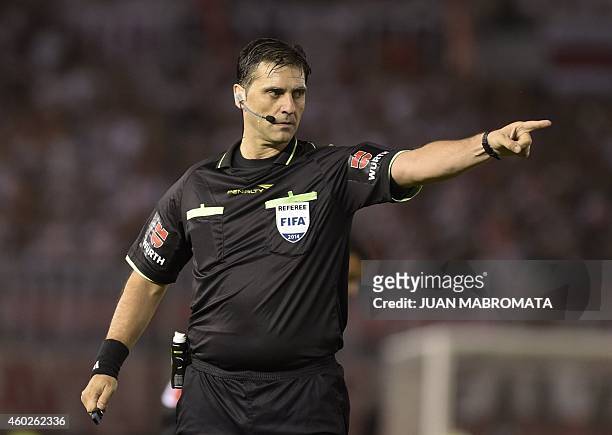 Uruguayan referee Dario Ubriaco gestures during the Copa Sudamericana 2014 second leg final football match beteween Argentina's River Plate and...