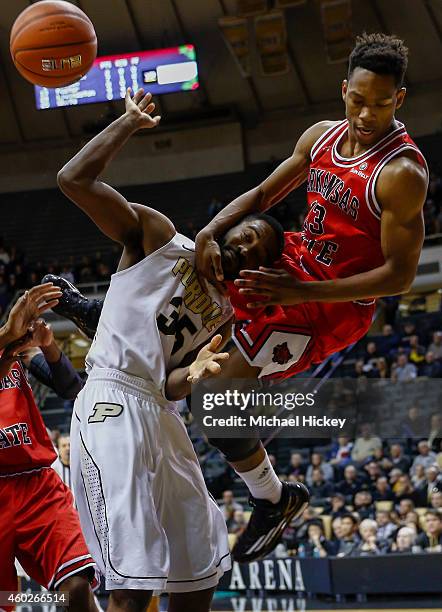 Rapheal Davis of the Purdue Boilermakers is fouled by C.J. Foster of the Arkansas State Red Wolves at Mackey Arena on December 10, 2014 in West...