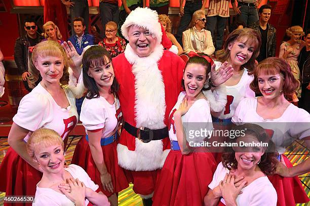 Bert Newton poses dressed as Santa Claus with cast members at the "Grease" musical at The Regent Theatre on December 11, 2014 in Melbourne,...