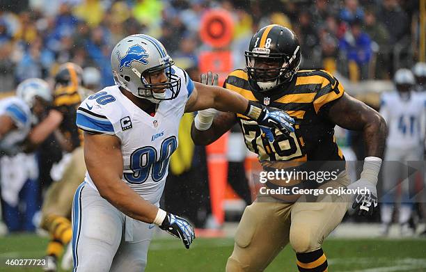 Defensive lineman Ndamukong Suh of the Detroit Lions pursues the play against offensive lineman Guy Whimper of the Pittsburgh Steelers during a game...