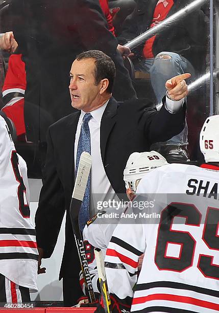 Assistance coach Kevin Dineen of the Chicago Blackhawks gives instructions against the New Jersey Devils during the game at the Prudential Center on...