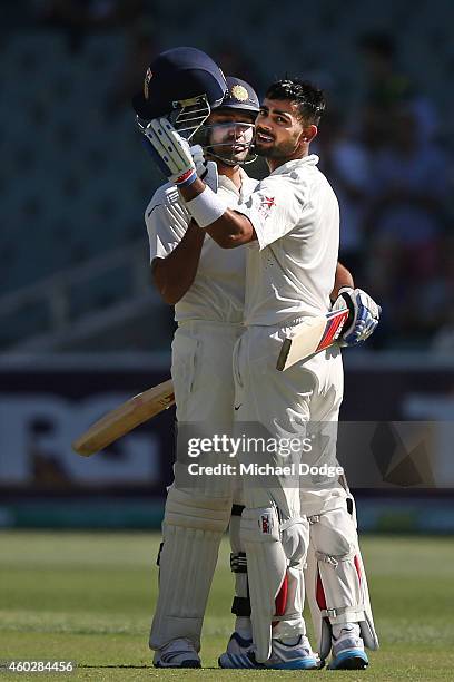 Virat Kohli of India celebrates his century with Karn Sharma during day three of the First Test match between Australia and India at Adelaide Oval on...