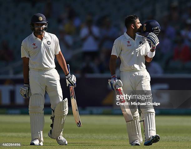 Virat Kohli of India celebrates his century with Karn Sharma during day three of the First Test match between Australia and India at Adelaide Oval on...