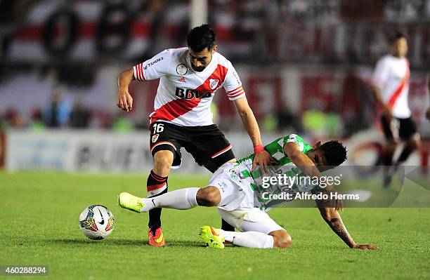 Ariel Rojas of River Plate and Luis Ruiz of Atletico Nacional fight for the ball during a second leg final match between River Plate and Atletico...