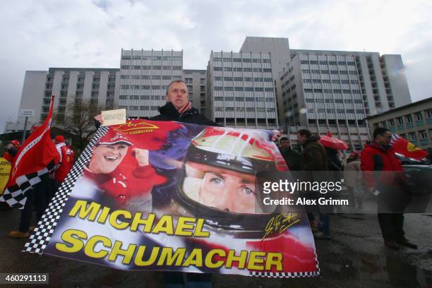 Fans gather outside the Grenoble University Hospital Centre to mark the 45th birthday of former German Formula One driver Michael Schumacher who is...