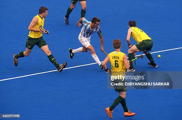 Argentina's Matias Paredes dribbles past Australia's Fergus Kavanagh during their Hero Hockey Champions Trophy 2014 quarter final match at Kalinga...