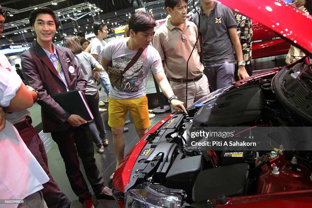 Visitors watch the engine of Mazda 2 during the 31st...