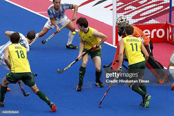 Australian hockey players Fergus Kavanagh, Eddie Ockenden Tristan White and goalkeeper Tyler Lovell trying to stop an attack from Argentineanplayers...