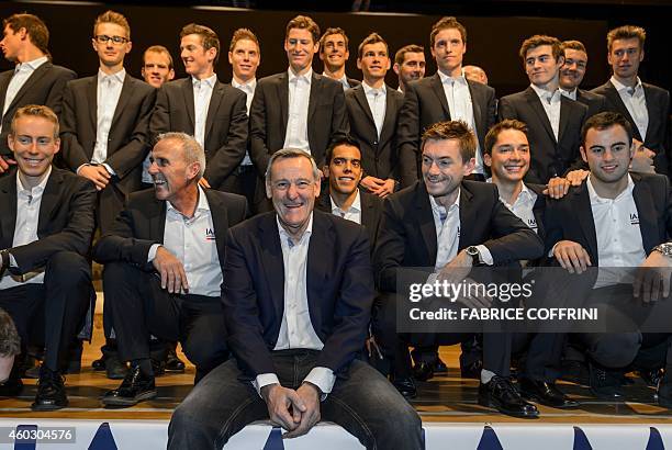 Cyling General Manager Michel Thetaz and racers pose for a family picture during the presentation of the 2015 squad of IAM Cycling team on December...