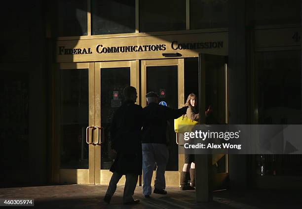 People enter the Federal Communications Commission building December 11, 2014 in Washington, DC. The commission held its monthly meeting as activists...