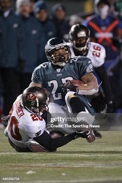 Duce Staley of the Philadelphia Eagles is tackled during a game against the Tampa Bay Buccaneers on January 19, 2003 at Veteran's Stadium in...