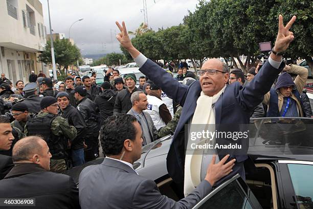 Incumbent President of Tunisia and presidential candidate Mohamed Moncef Marzouki flashes victory sign during his visit to northern Siliana district...