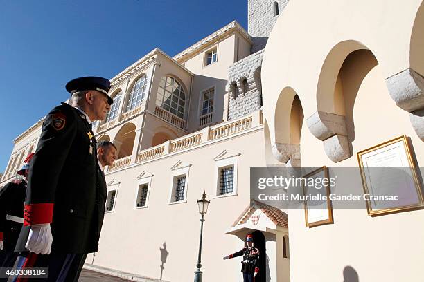 Colonel Luc Frigan looks at the official announcement of the birth of the royal twins Prince Jacques and Princess Gabriella after placing it onto the...