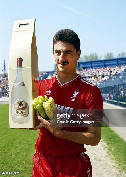 Liverpool striker poses with his 'leaving presents' from Chelsea of a large bottle of Frascati, and a bunch of celery before his last match against...