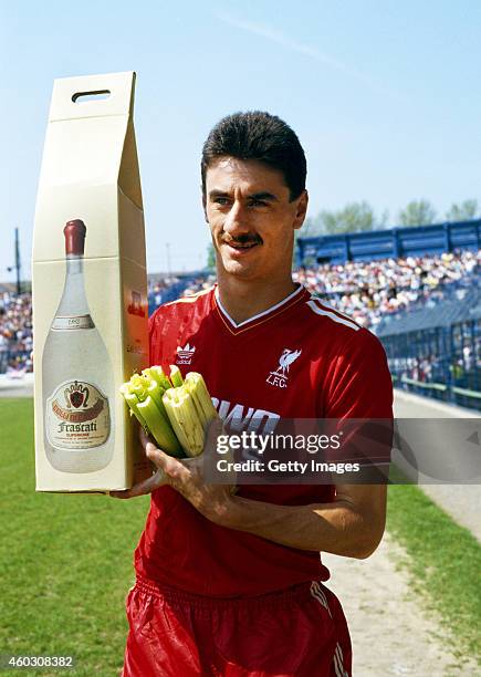 Liverpool striker poses with his 'leaving presents' from Chelsea of a large bottle of Frascati, and a bunch of celery before his last match against...