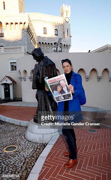 Woman reads an article about yesterday's birth of the royal twins Prince Jacques and Princess Gabriella outside the Monaco Palace on December 11,...
