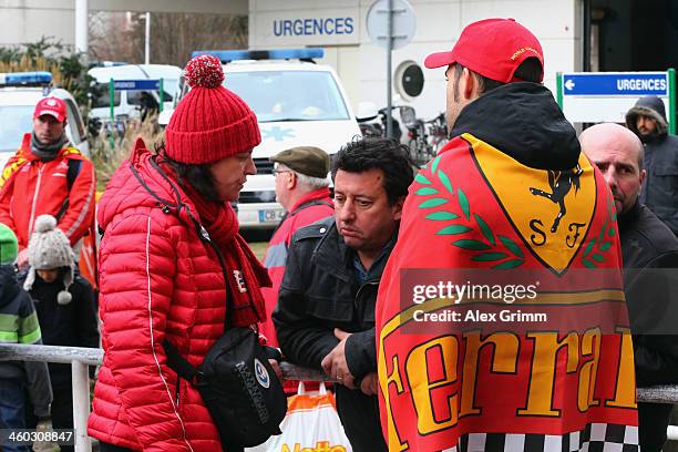 Fans gather outside the Grenoble University Hospital Centre to mark the 45th birthday of former German Formula One driver Michael Schumacher who is...