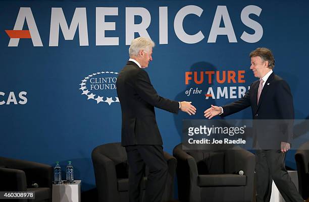 Former President Bill Clinton greets Juan Manuel Santos, President of the Republic of Colombia, as they attend the Clinton Foundations Future of the...