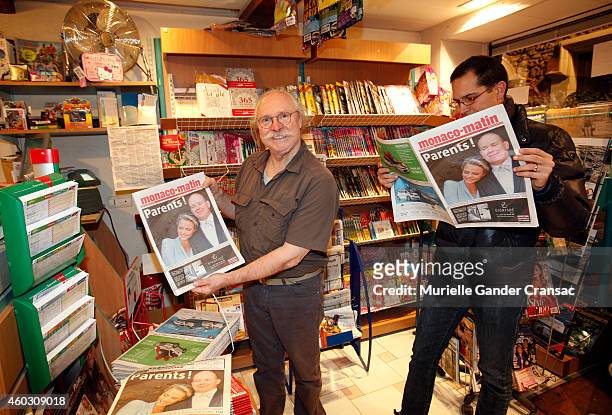 Shopkeeper arranges newspapers with displaying the front page story of the birth of the royal twins Prince Jacques and Princess Gabriella outside the...