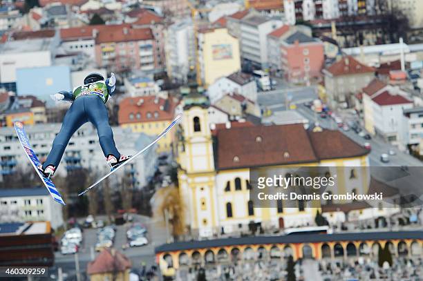 Anders Fannemel of Norway soars towards the Wiltener Basilica during his first training jump on day 1 of the Four Hills Tournament event at Bergisel...