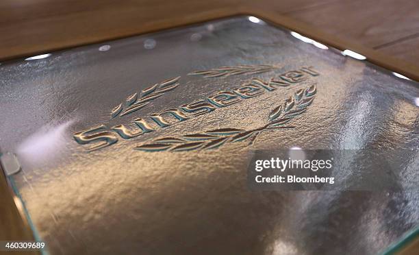 Logo sits embedded in a table aboard a luxury yacht, manufactured by Sunseeker International Ltd., a unit of China's Dalian Wanda Group, ahead of the...