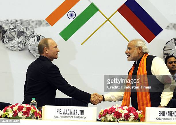 Indian Prime Minister Narendra Modi shaking hand with Russian President Vladimir Putin during the inauguration of the World Diamond Conference at...