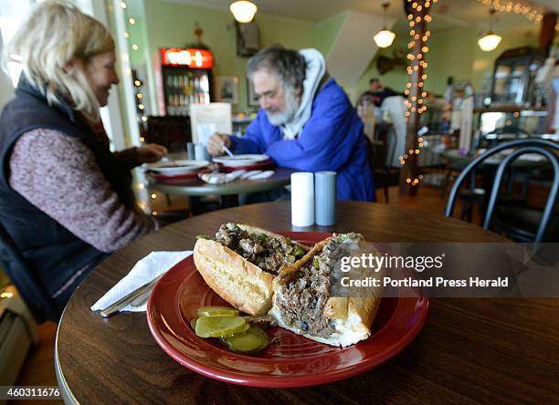 Shaved rib eye steak sub with peppers, onions, mushrooms and melted cheese served at the Winnegance General Store in Bath as Tricia Santi and Aram...