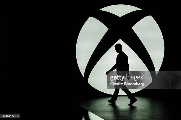 Bloomberg's Best Photos 2014: The silhouette of Ralph Fulton, design director for Forza Horizon at Playground Games, is seen walking past the...
