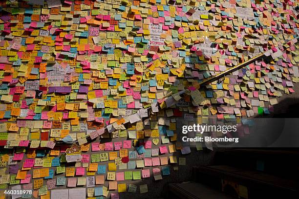 Bloomberg's Best Photos 2014: A commuter's shadow is cast on notes hanging on a wall outside the Central Government Offices in Hong Kong, China, on...