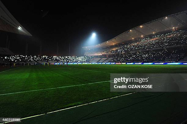 Supporters shine the lights of their mobile phones after the match was suspended following a power failure during UEFA Europa League Group C football...