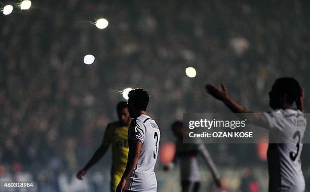 Tottenham's and Besiktas' players wait after the match was suspended following a power failure during the UEFA Europa League Group C football match...