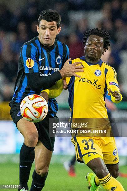 Brugge's Fernando Menegazzo and Helsinki's midfielder Anthony Annan vie for the ball during the UEFA Europa League group B football match between...