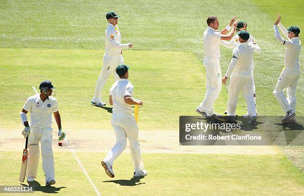 Peter Siddle of Australia celebrates after taking the wicket of Karn Sharma of India during day four of the First Test match between Australia and...