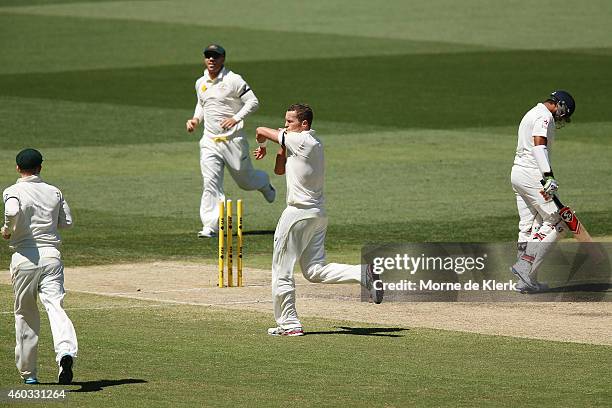 Peter Siddle of Australia kisses the black armband as he celebrates getting the wicket of Karn Sharma of India during day four of the First Test...