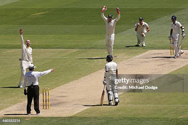 Nathan Lyon of Australia celebrates his wicket of Wriddhiman Saha of India caught out by Shane Watson during day four of the First Test match between...