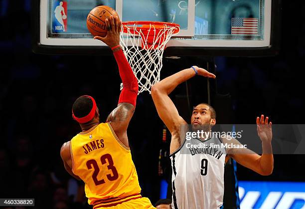 LeBron James of the Cleveland Cavaliers in action against Jerome Jordan of the Brooklyn Nets at Barclays Center on December 8, 2014 in the Brooklyn...