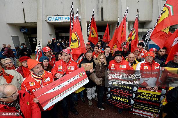 Fans gather in front of the main entrance of Grenoble University Hospital Centre where former German Formula One driver Michael Schumacher is being...