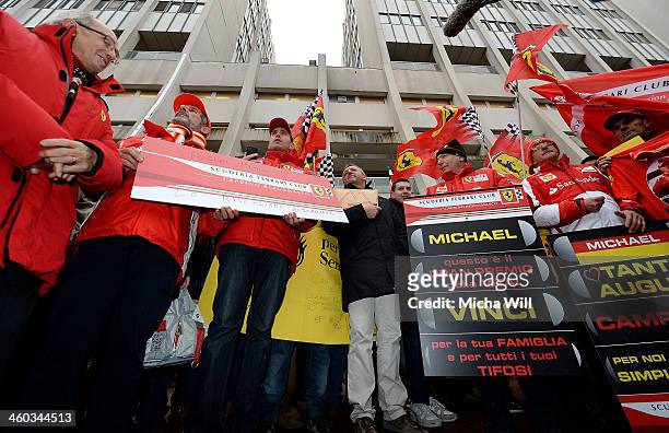 Fans gather in front of the main entrance of Grenoble University Hospital Centre where former German Formula One driver Michael Schumacher is being...