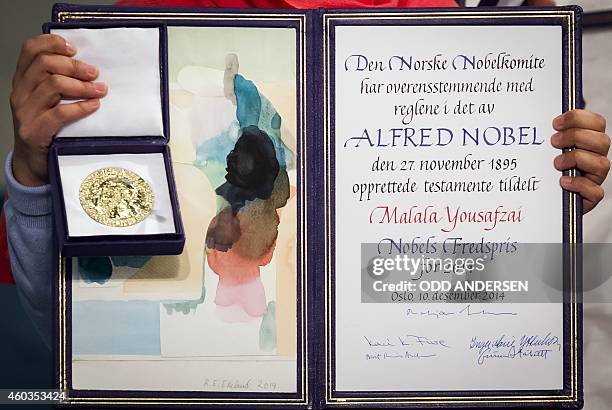 Nobel Peace Prize laureate Malala Yousafzai displays her medal and diploma during the Nobel Peace Prize awards ceremony at the City Hall in Oslo,...