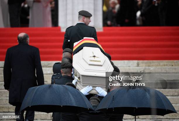 Soldiers carry the coffin of late Queen Fabiola of Belgium at the Saint Michael and Saint Gudula Cathedral in Brussels on December 12, 2014 during...