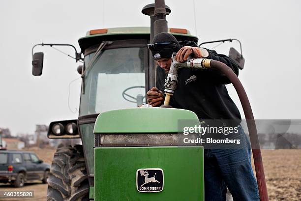 Michlig Energy driver Jake Gould delivers diesel fuel to a John Deere & Co. Tractor in Manlius, Illinois, U.S., on Wednesday, Dec. 10, 2014. Oil...