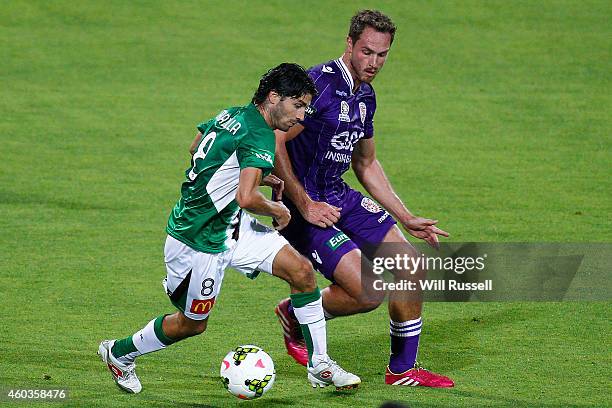 Zenon Caravella of the Jets controls the ball under pressure from Rostyn Griffiths of the Glory during the round 11 A-League match between Perth...