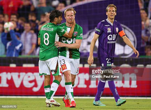 Zenon Caravella of the Jets consoles David Carney after a wayward shot on goal during the round 11 A-League match between Perth Glory and Newcastle...