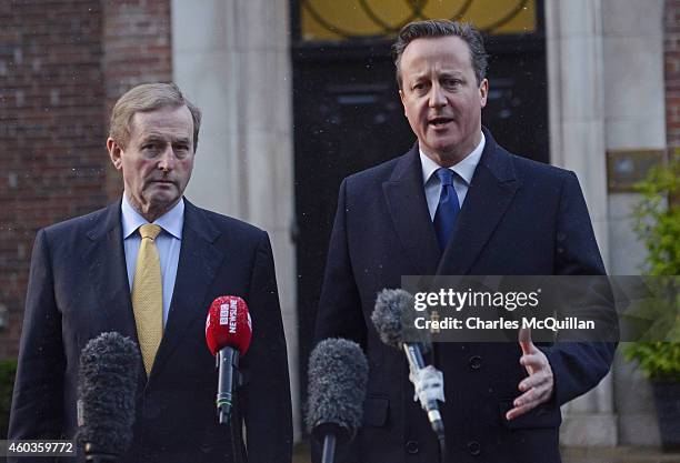 Irish Taoiseach Enda Kenny and Prime Minister David Cameron address the media before departing the cross party talks at Stormont on December 12, 2014...