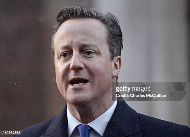 Prime Minister David Cameron addresses the media before departing the cross party talks at Stormont on December 12, 2014 in Belfast, Northern...