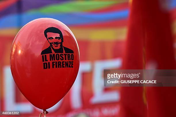 Balloon bearing a portrait of Italian Prime Minister Matteo Renzi reading "the monster of Florence" is diplayed in Milan during an eight-hour strike...