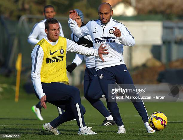 Cicero Moreira Jonathan competes with Nemanja Vidic during FC Internazionale training session at the club's training ground on December 12, 2014 in...