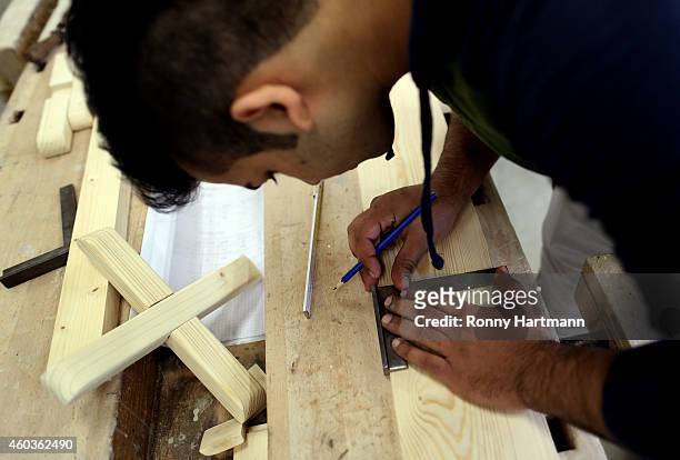 Refugee Jose Manuel from Portugal who arrived in Germany without family members trains in wood-working techniques at a job-training center on...