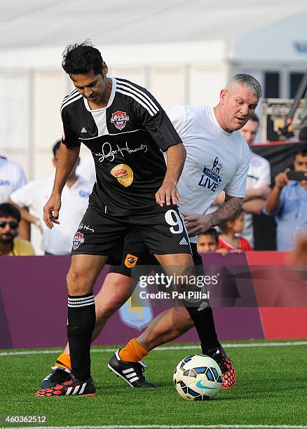 Bollywood actor Dino Morea tackles Dean Windass, Hull city Legend in action during an exhibition match played between BPL legends and All star FC...